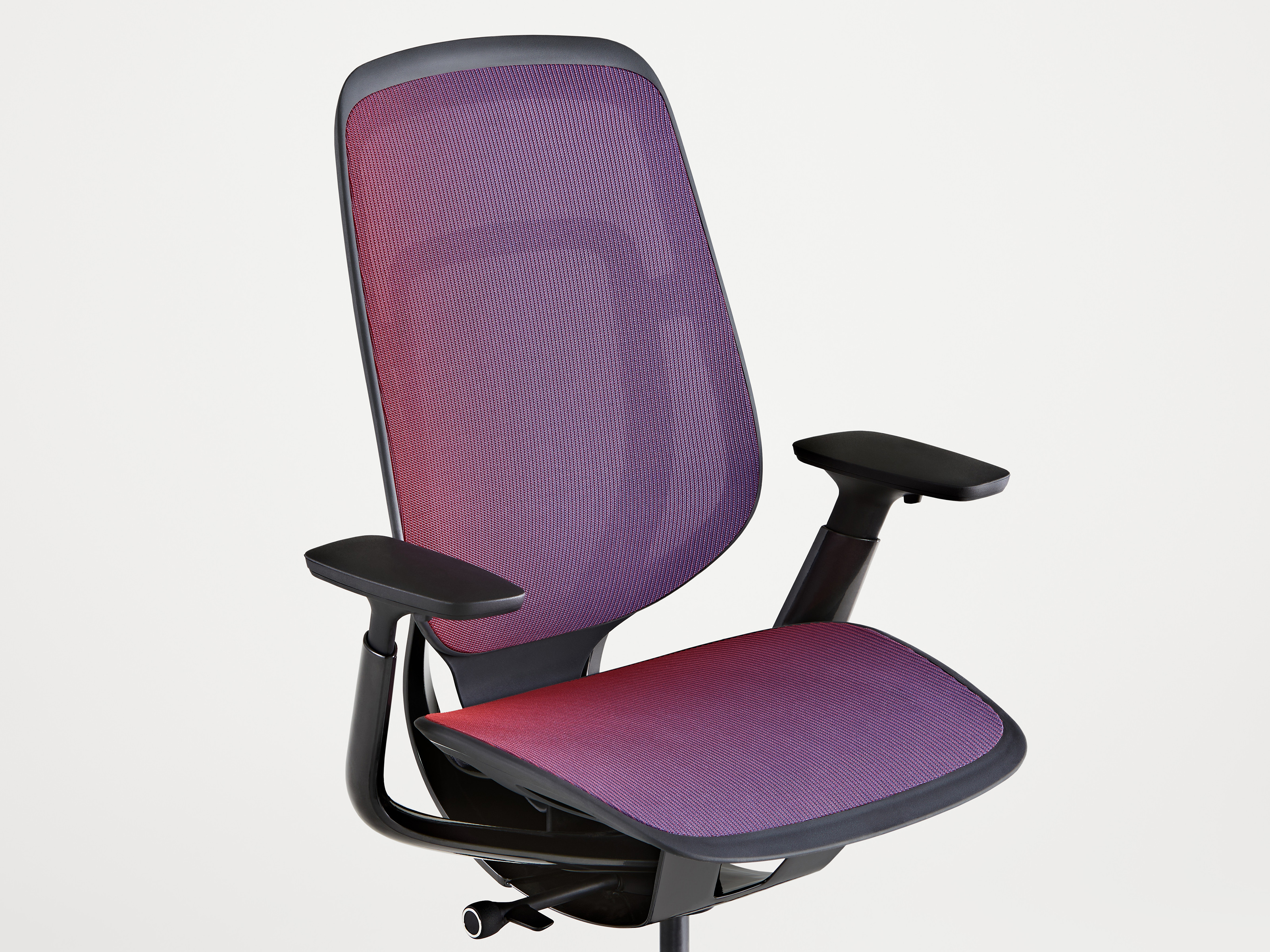 angled view of a Steelcase Karman chair with purple mesh