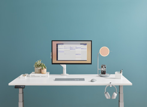 white desk with an eclipse light and a computer on it