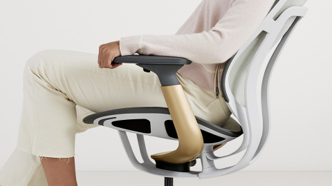 woman sitting on a white karman chair